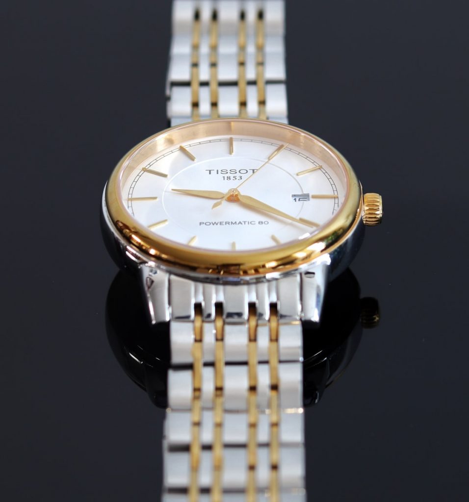 gold and silver round analog watch