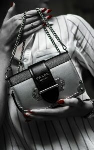 black leather handbag on white textile