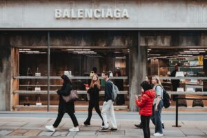 a group of people walking outside a store, Balenciaga