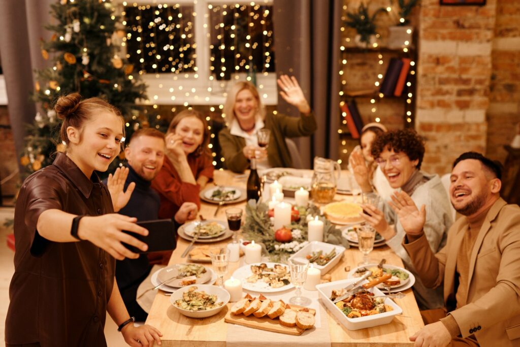 Family Celebrating Christmas Dinner While Taking Selfie, dinner party