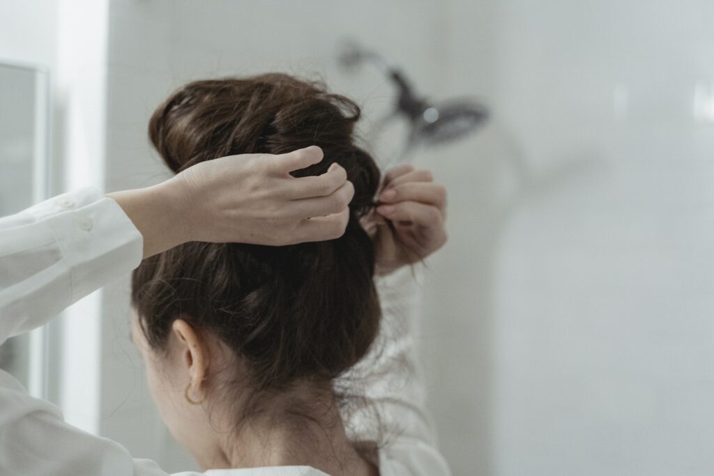 Close-up of Woman Making Hairstyle