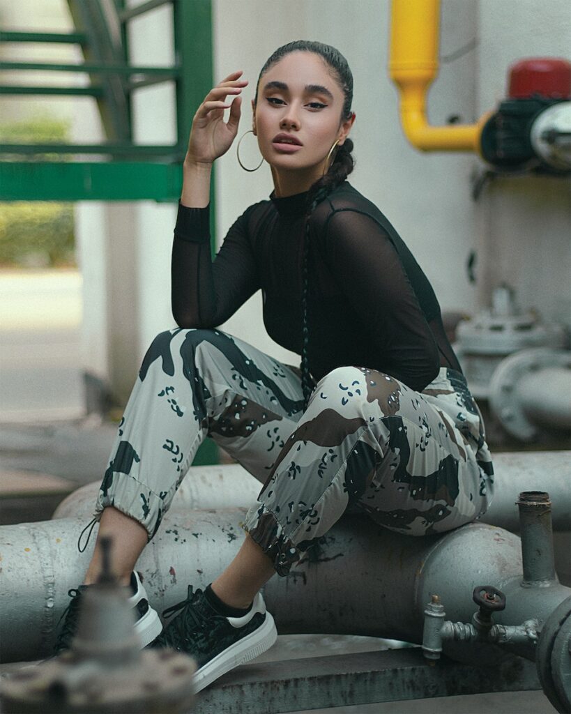 A Woman in black Long Sleeves and Camouflage Pants