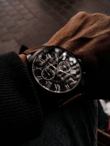 person wearing black leather strap silver round chronograph watch, Fossil watch