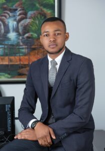 man in black suit jacket sitting on chair, Suit and tie