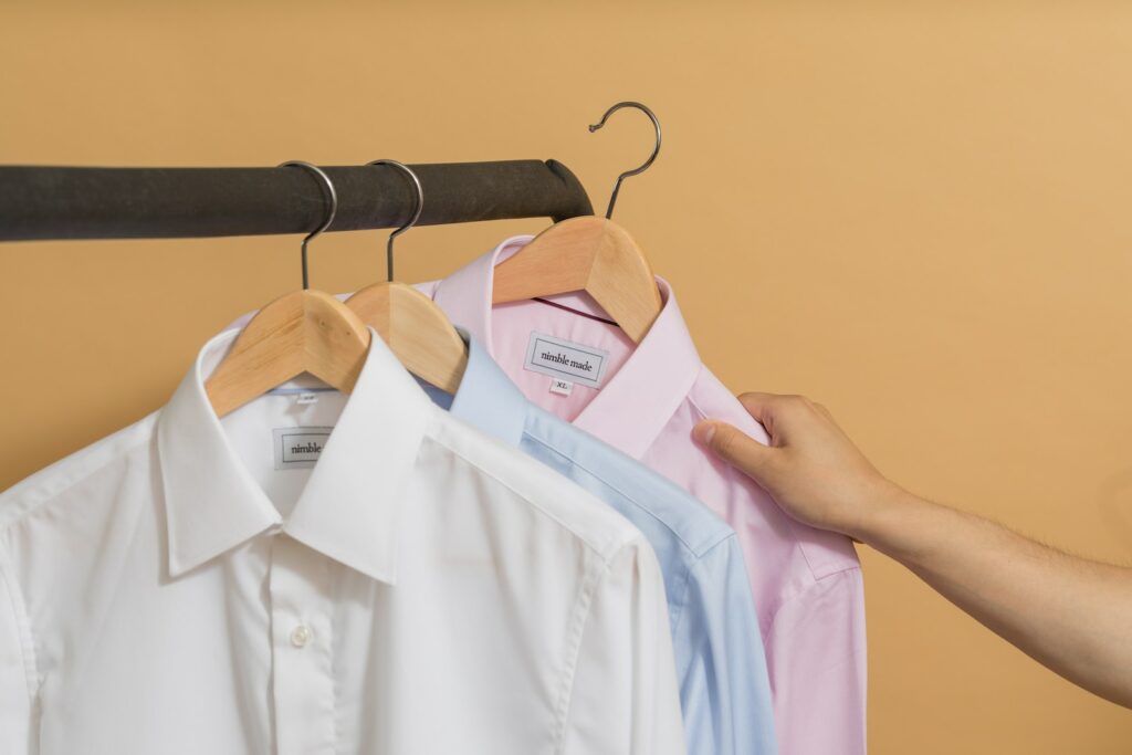 white button up shirt on brown clothes hanger