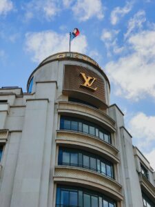 white and brown concrete building under blue sky during daytime, Louis Vuitton