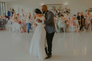 Bride and Groom Dancing on the Floor in front of their Visitors