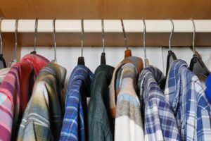 a bunch of shirts hanging on a rack